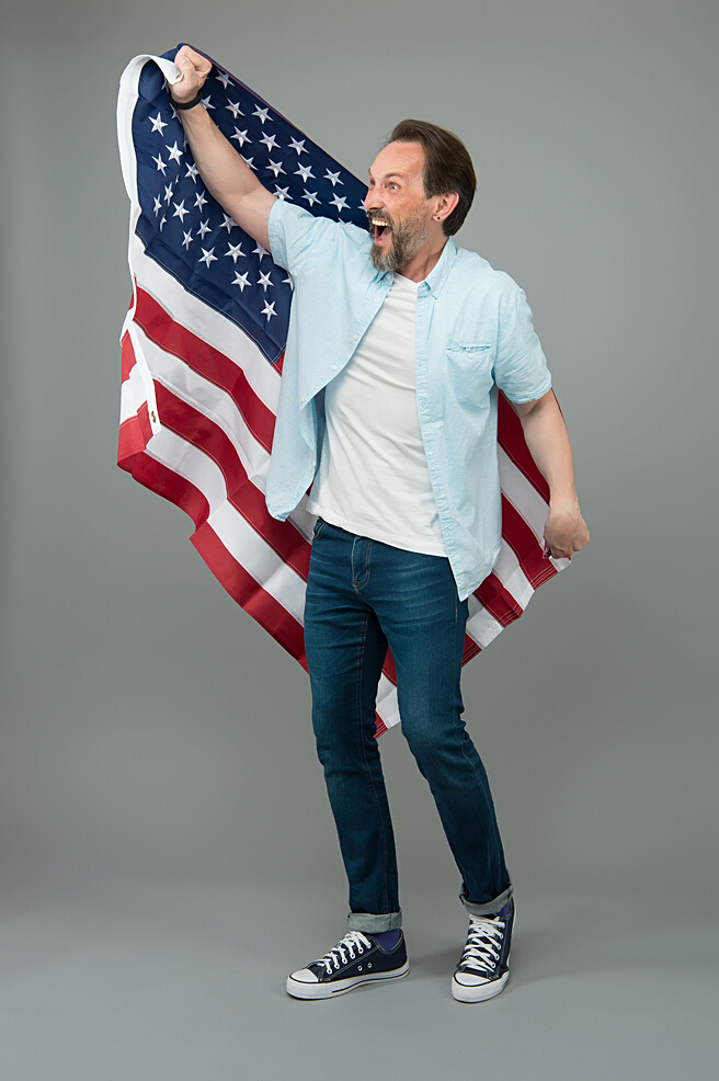 Visa free. Happy man get USA visa grey background. Visa applicant hold usa flag. Applying for immigrant visa to american citizenship. July 4th. Independence day
